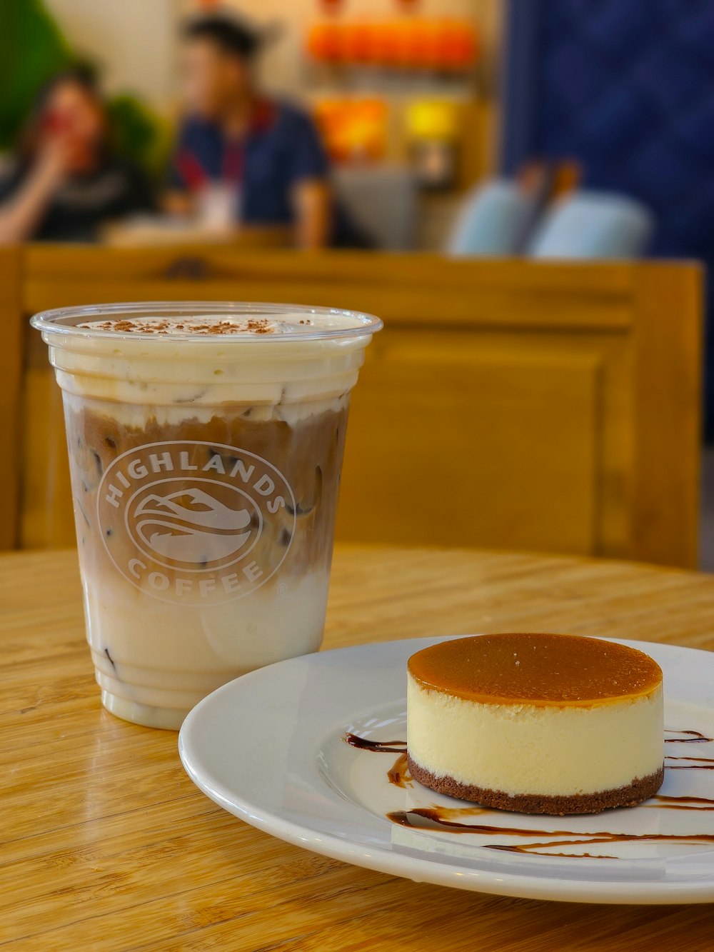 a cup of coffee and a cheesecake on a table