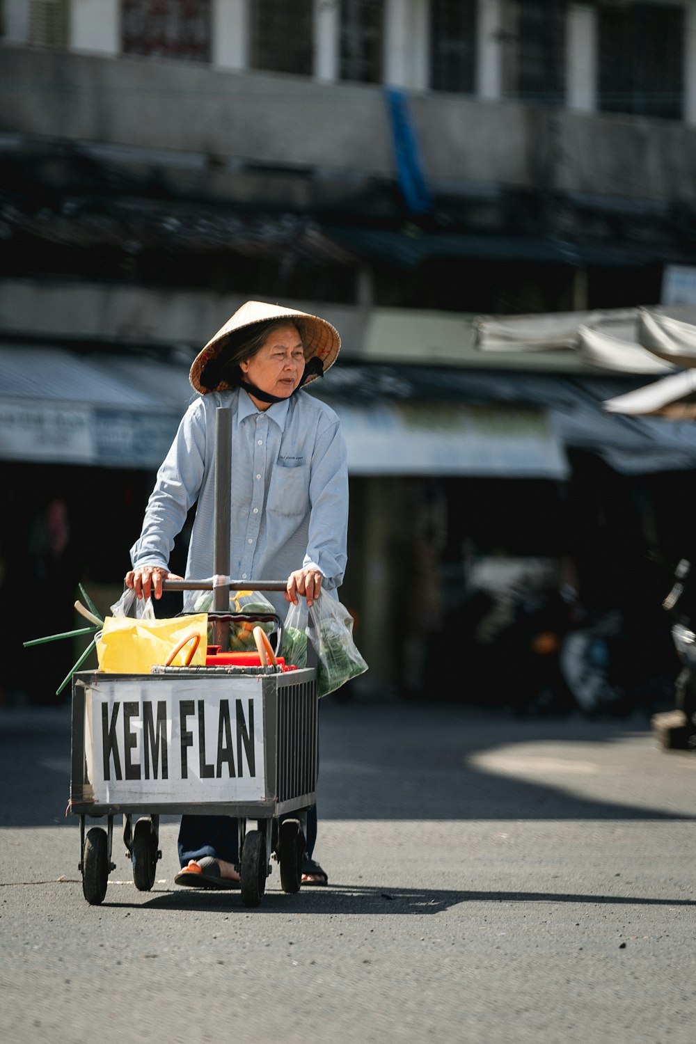 a young boy pushing a cart with a sign on it