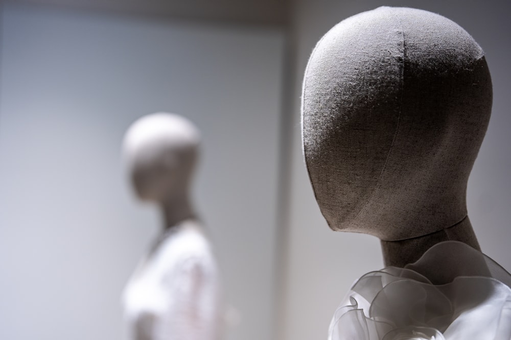 a white mannequin head in a white room