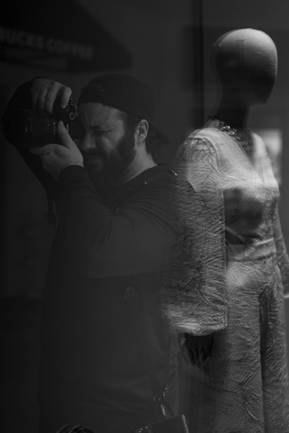 a man taking a picture of a mannequin