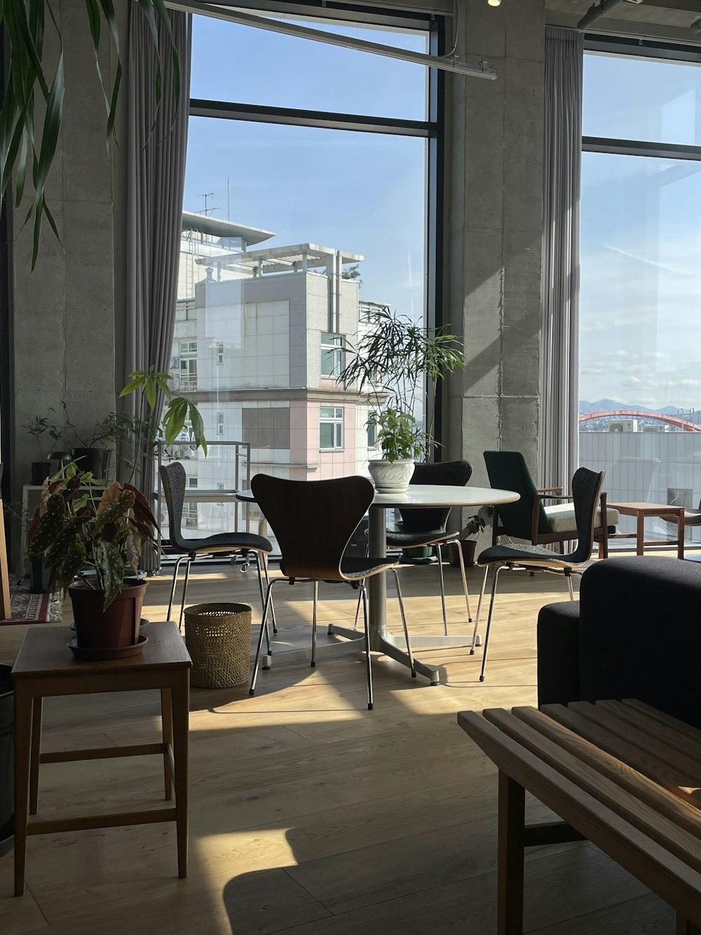 a living room filled with furniture and large windows