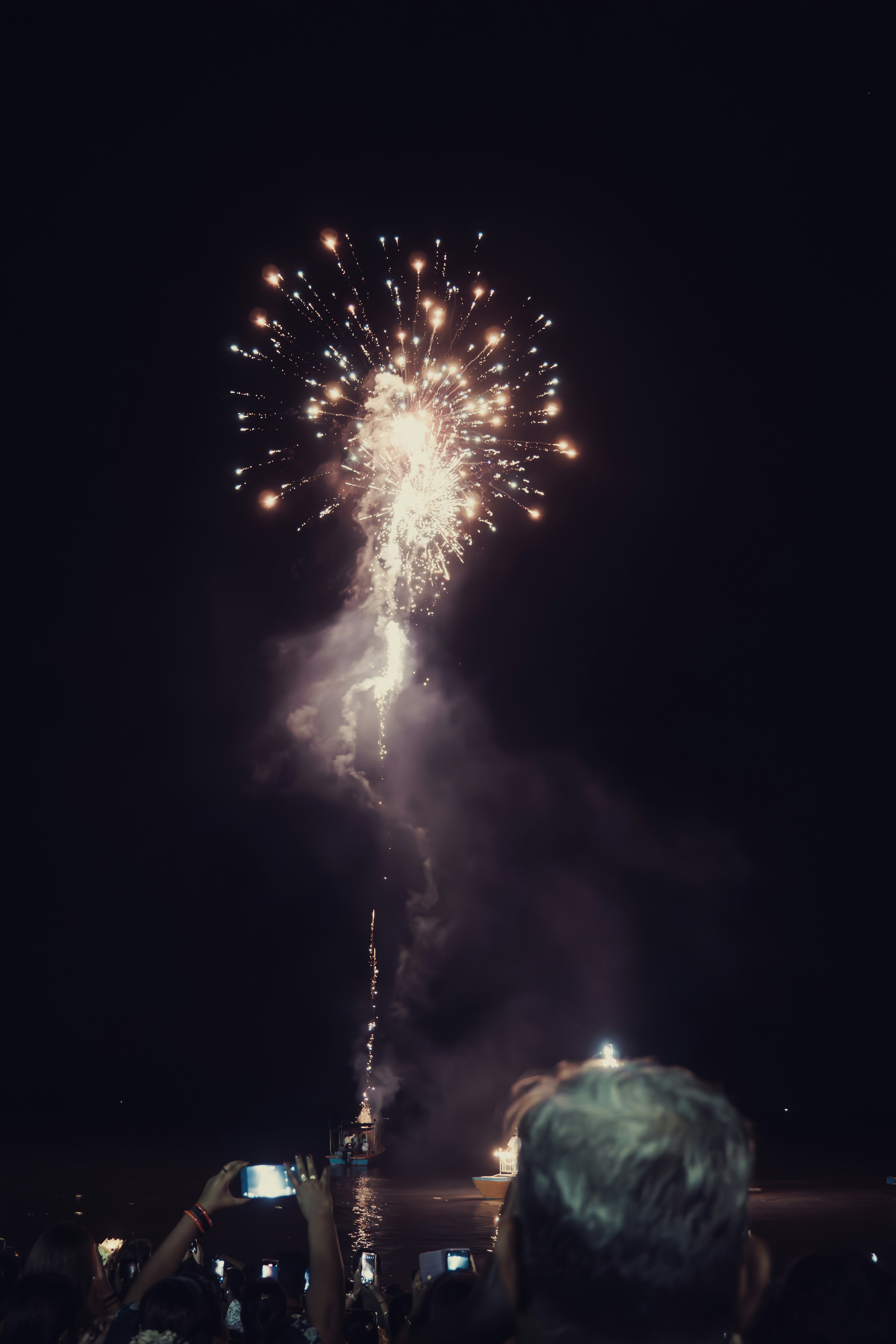 A crowd of people watching a fireworks display