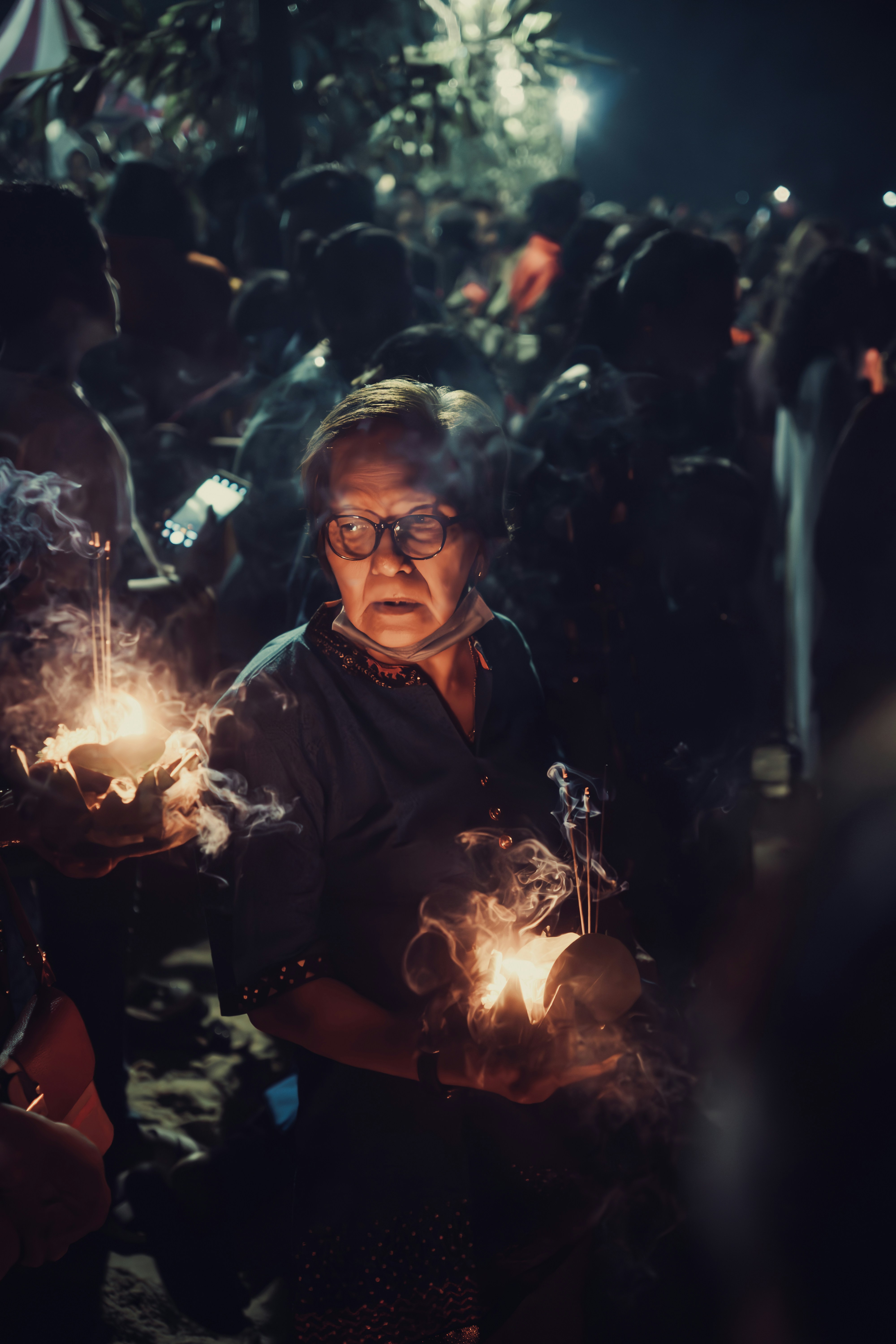 A group of people holding lit candles in their hands