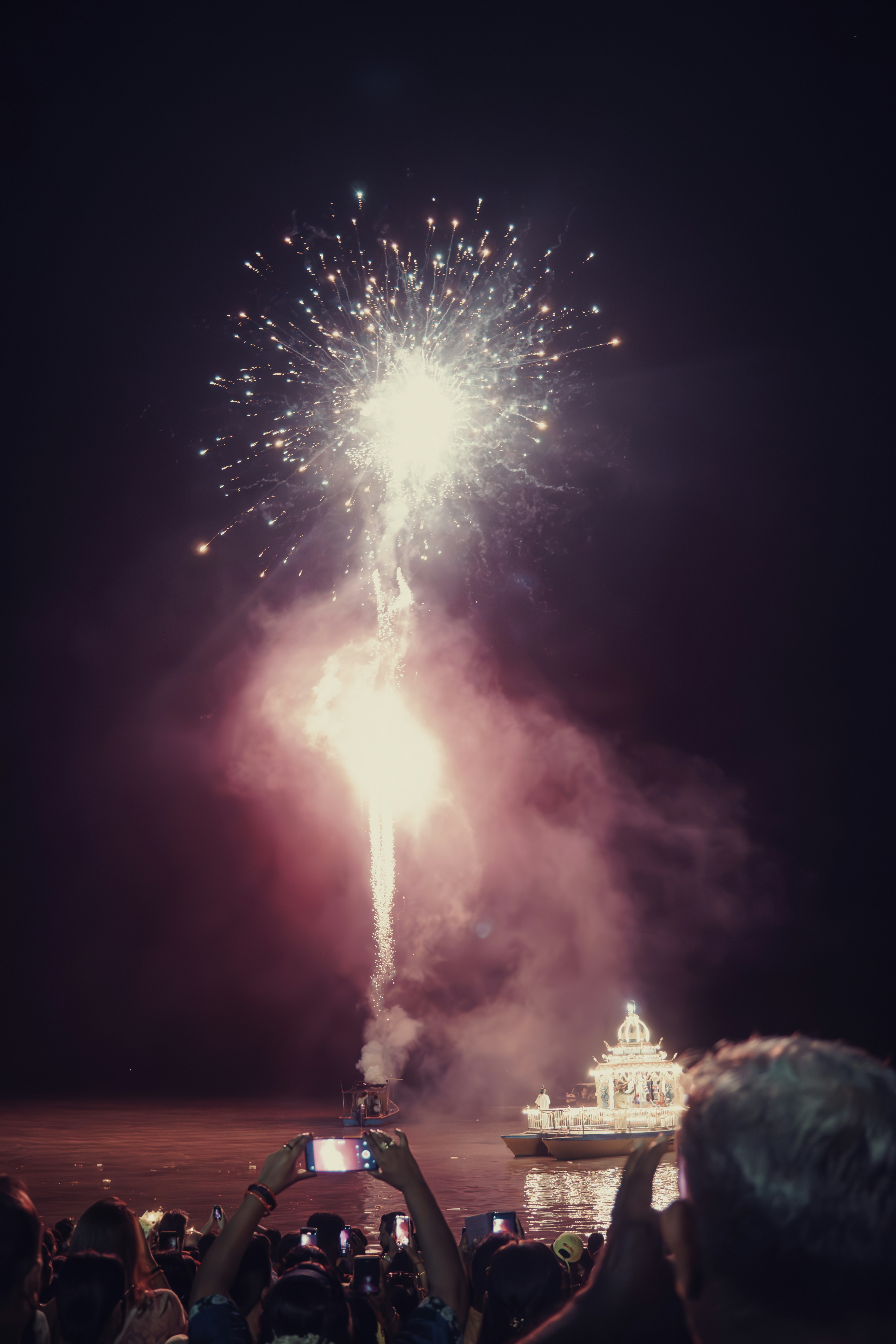 A crowd of people watching a fireworks display
