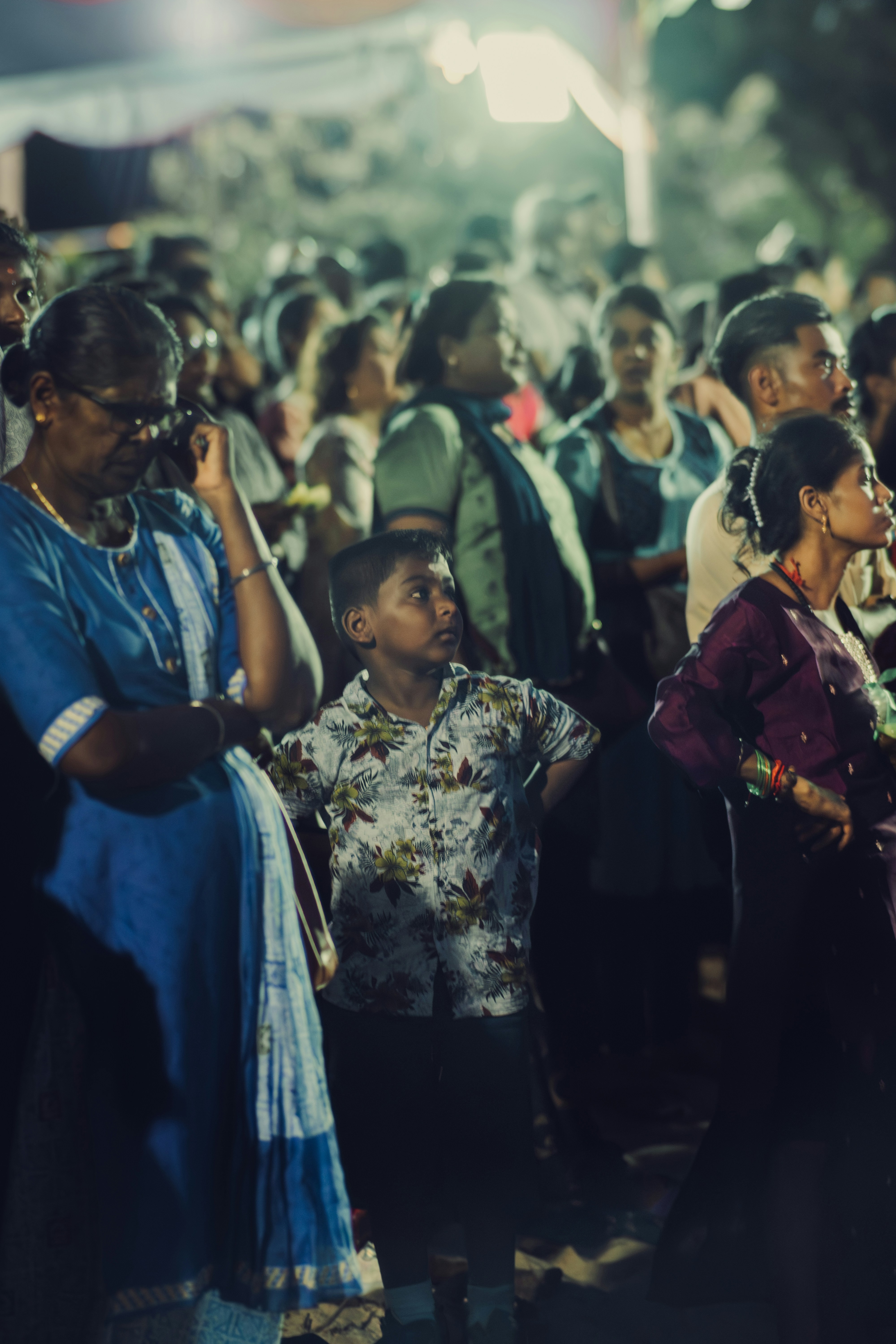 A crowd of people standing around each other