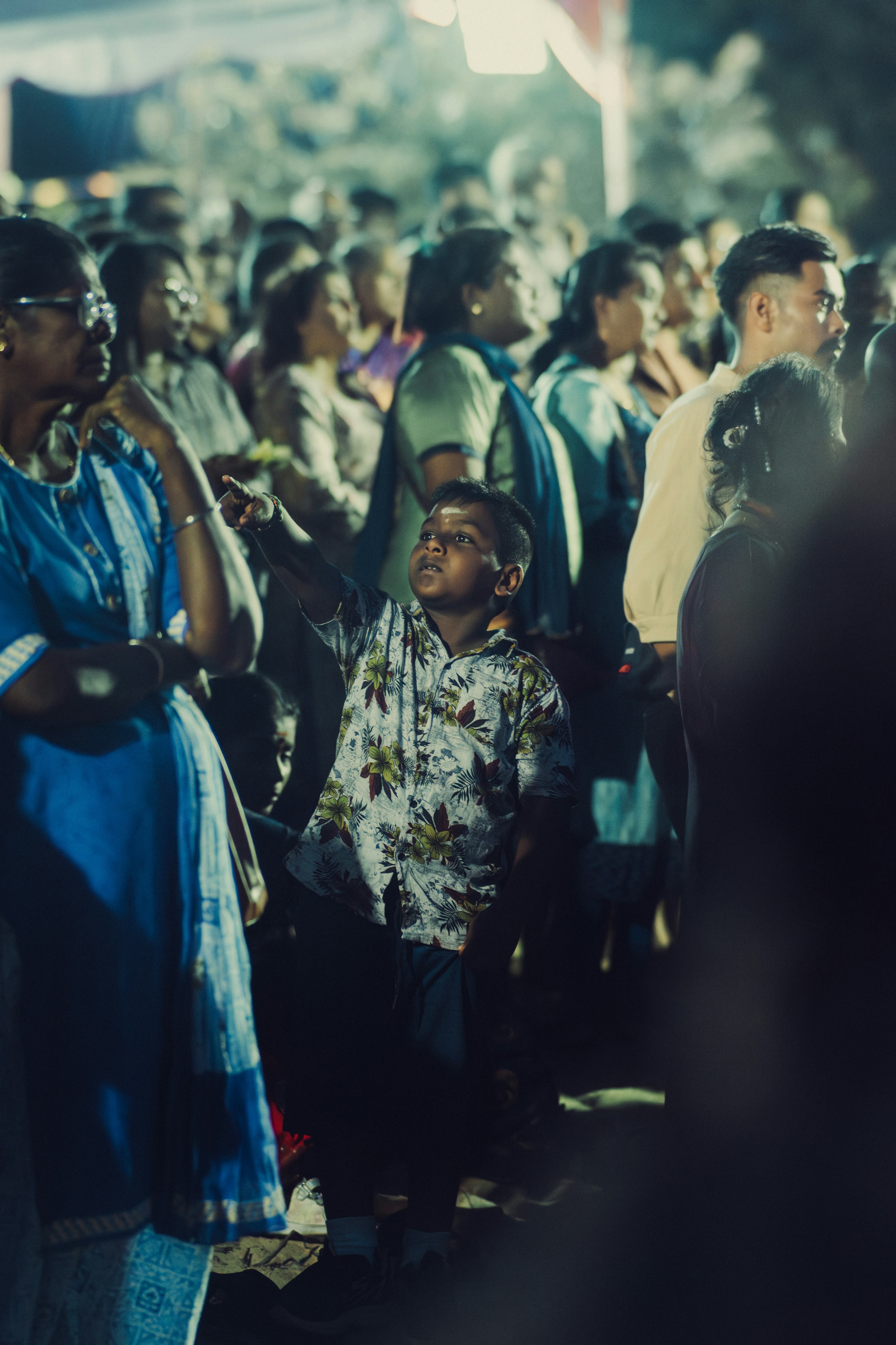 A crowd of people standing around each other
