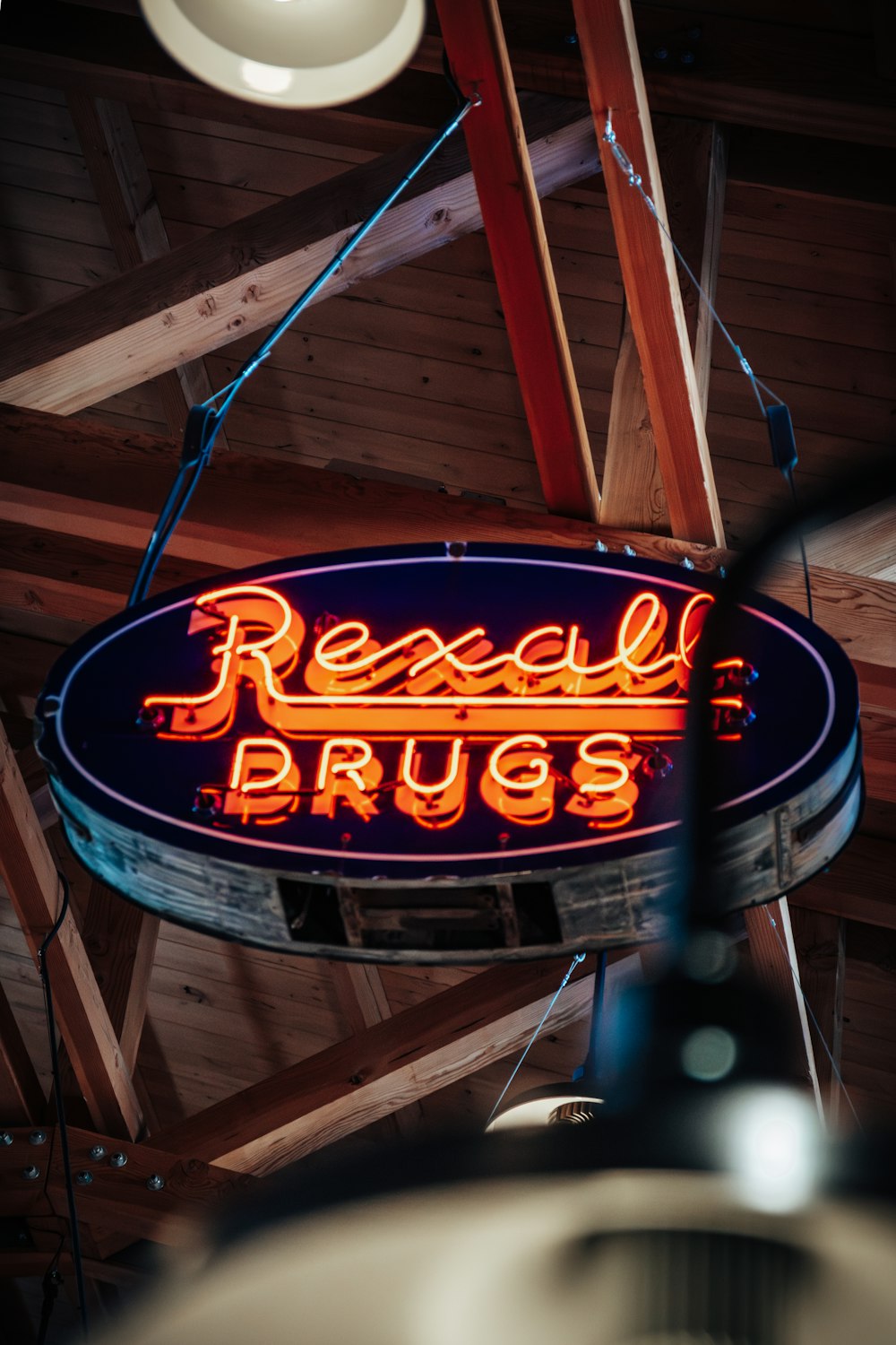 a neon sign hanging from the ceiling of a restaurant