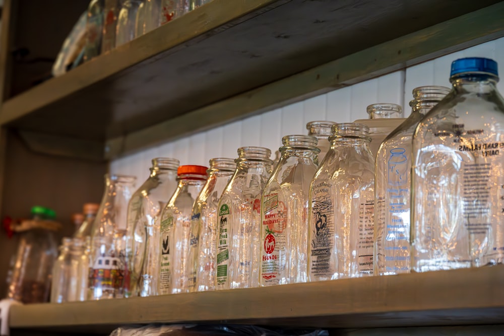 a row of empty glass bottles on a shelf