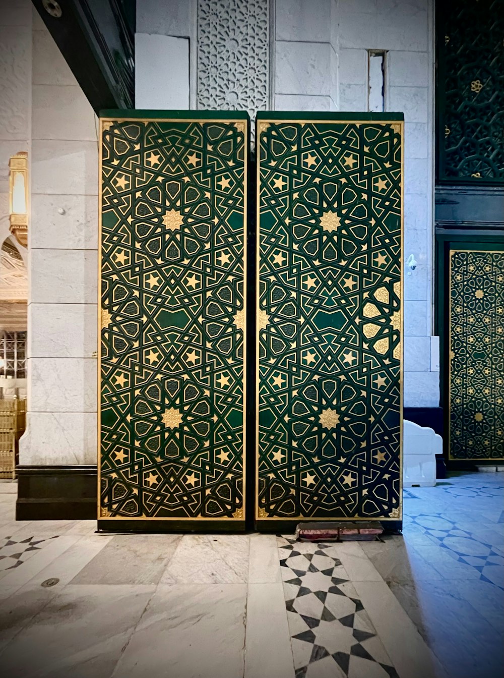 a green and gold door sitting inside of a building