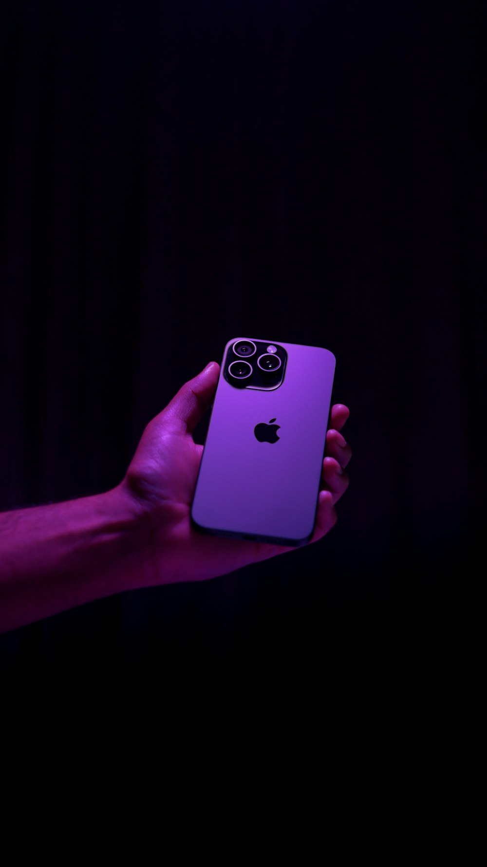 a person holding a purple iphone in their hand