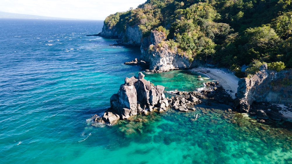 an aerial view of a beach with clear blue water