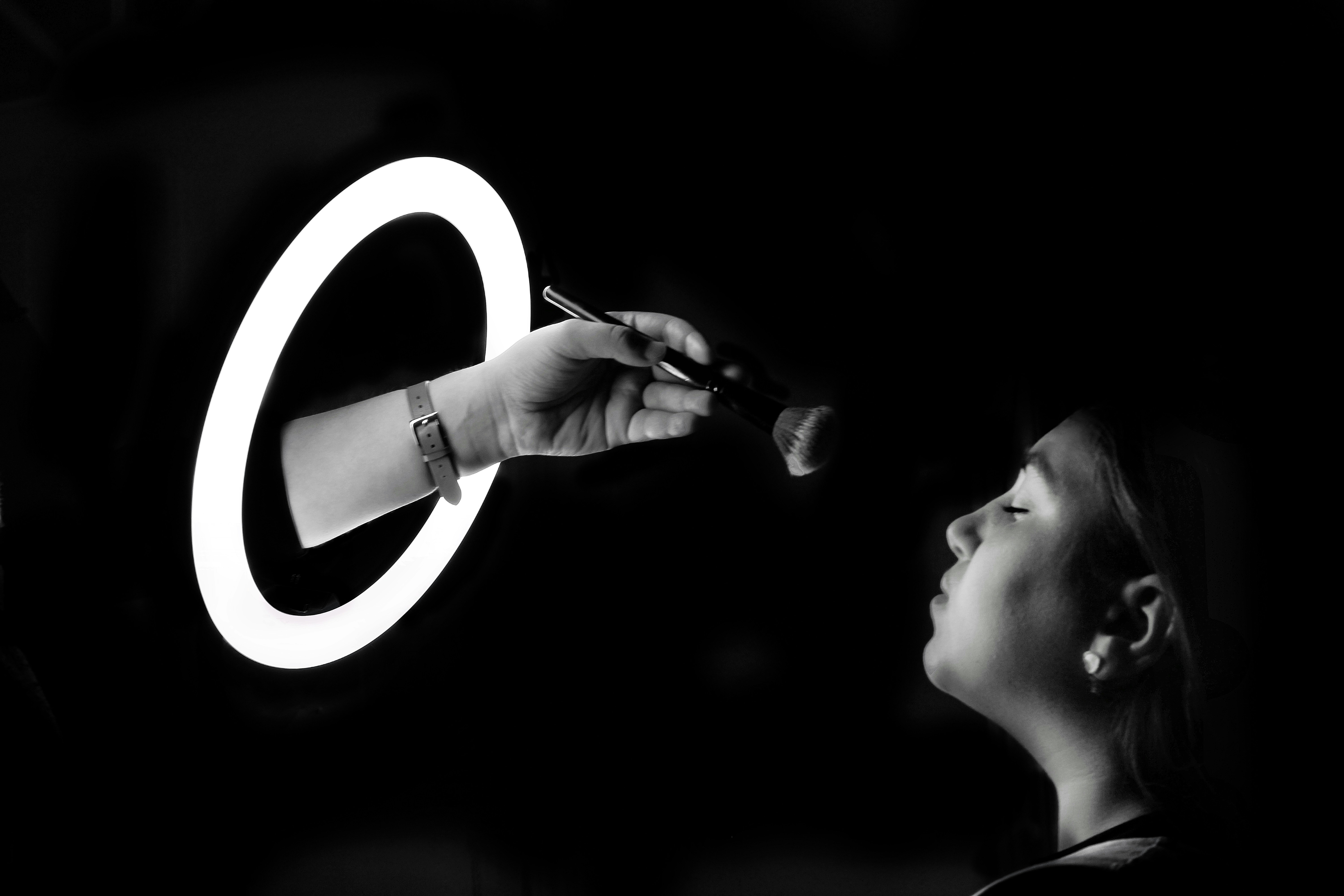 A woman is writing on a wall with a pen