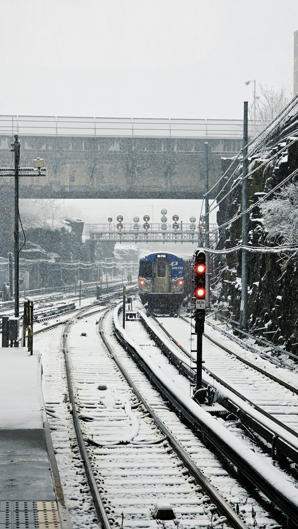 a train traveling down train tracks in the snow