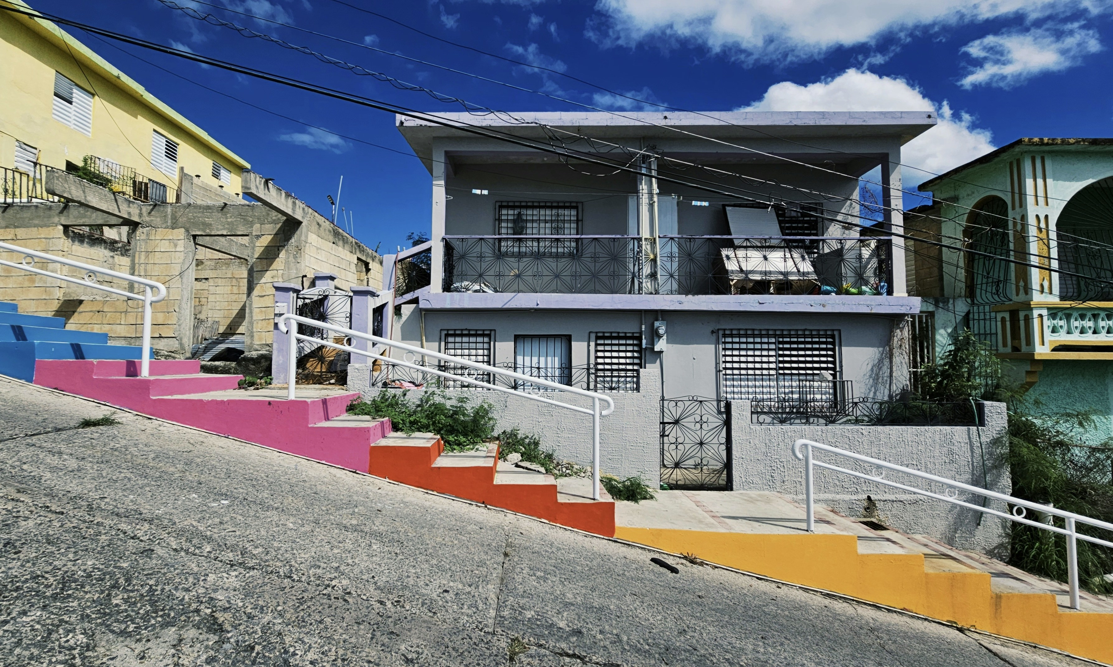 a multicolored building with a staircase going up the side