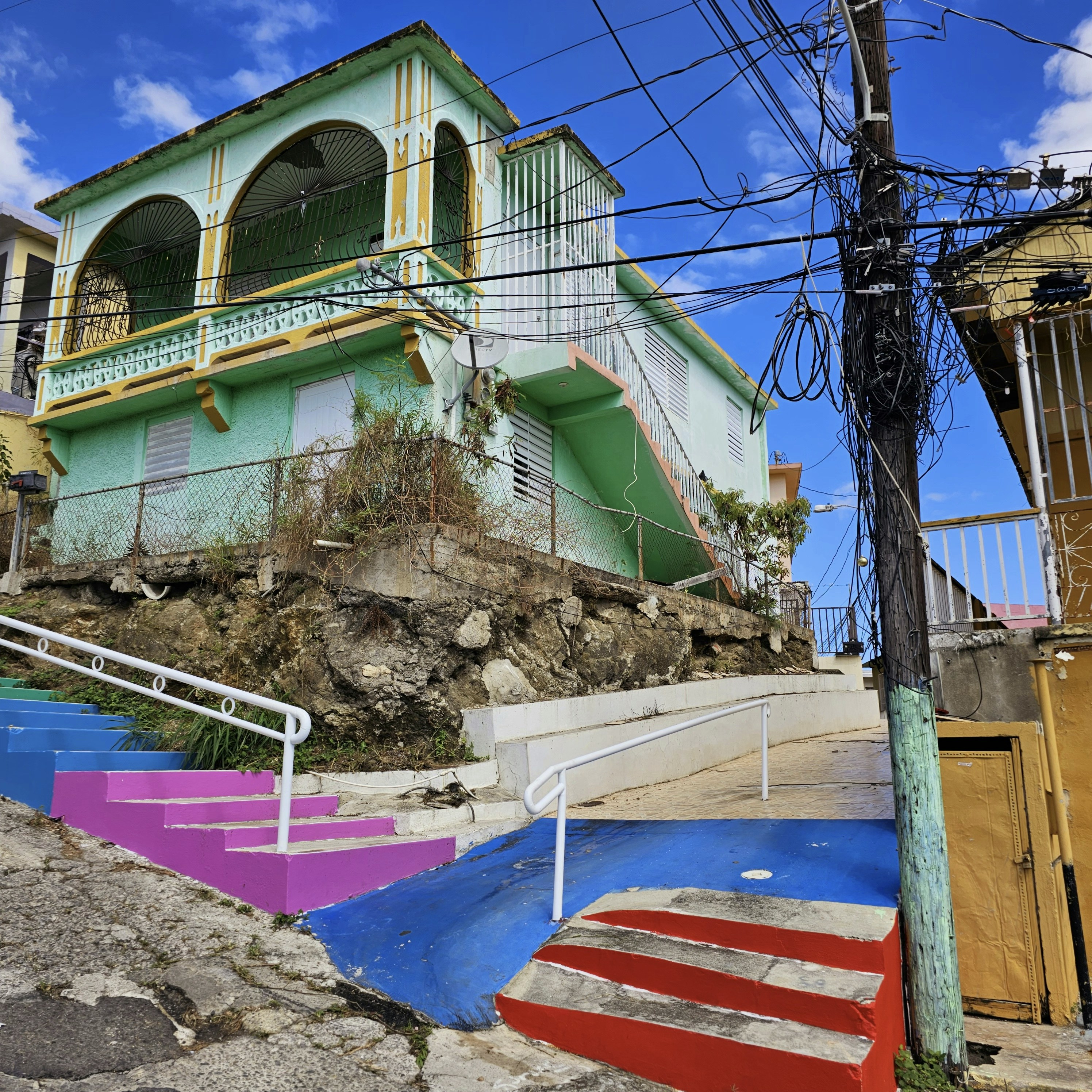 a multicolored building with a staircase going up it