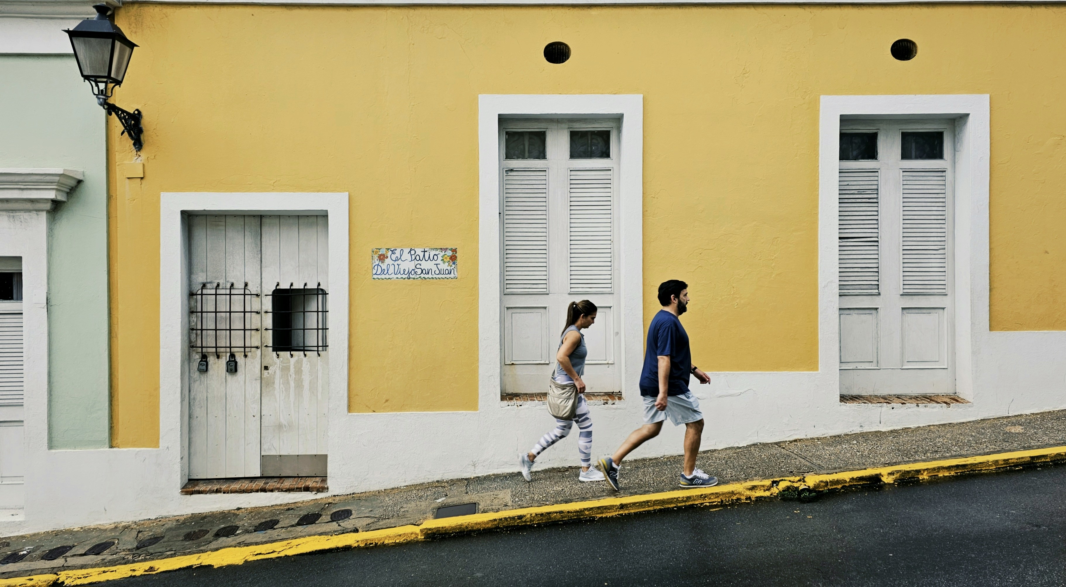 a man and a woman walking down the street