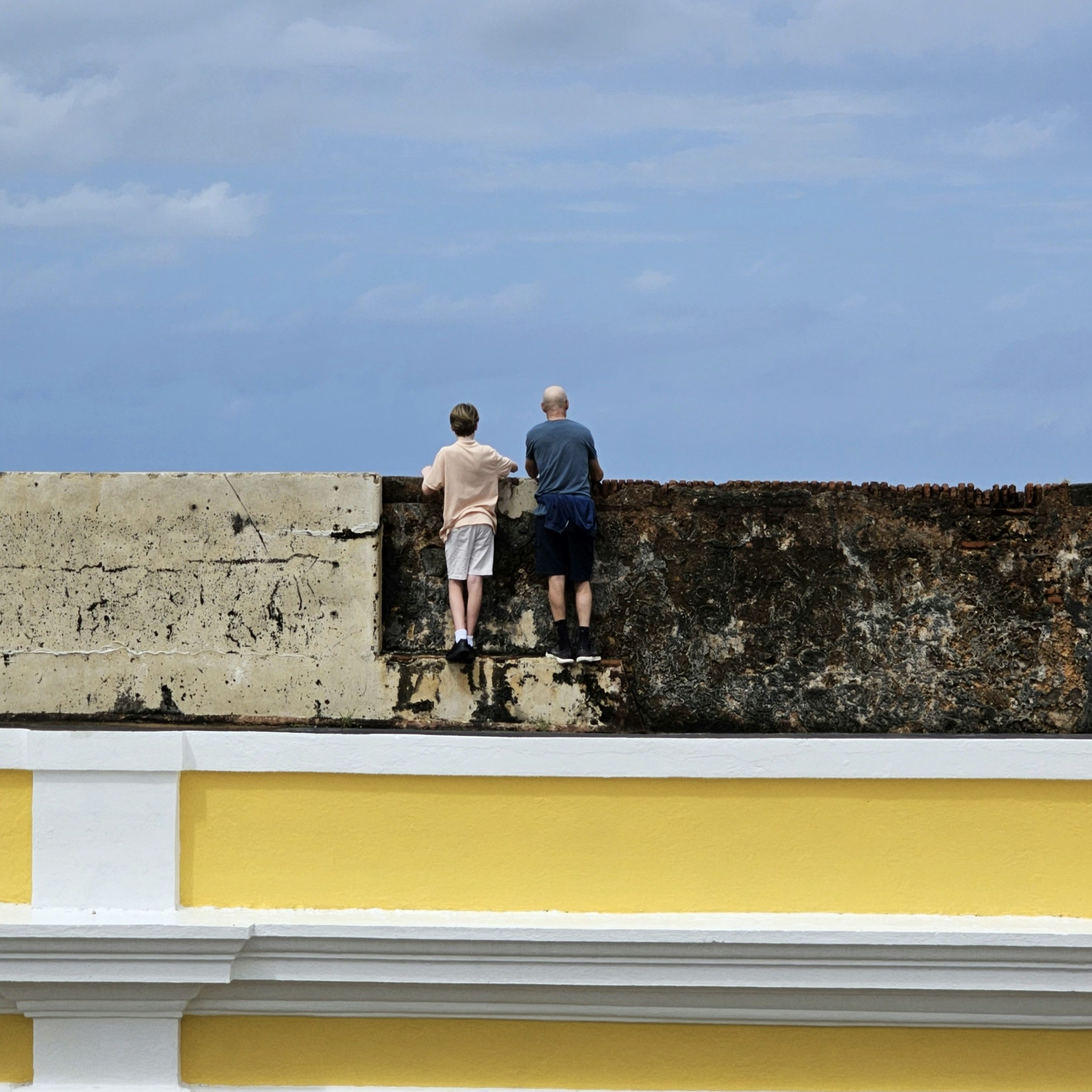 a couple of people that are standing on a wall