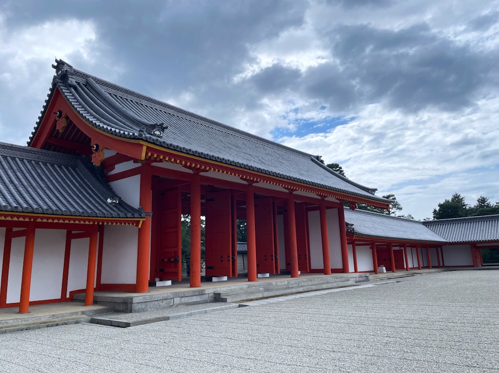 a red and white building with a sky background