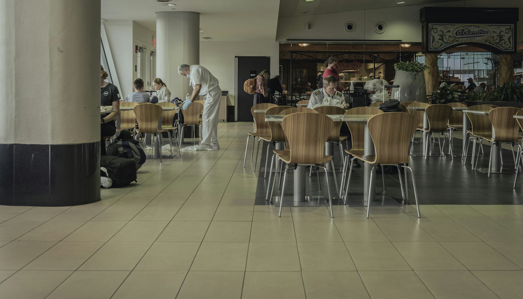 Cafeteria seating and a tiled floor during a mid-shift clean