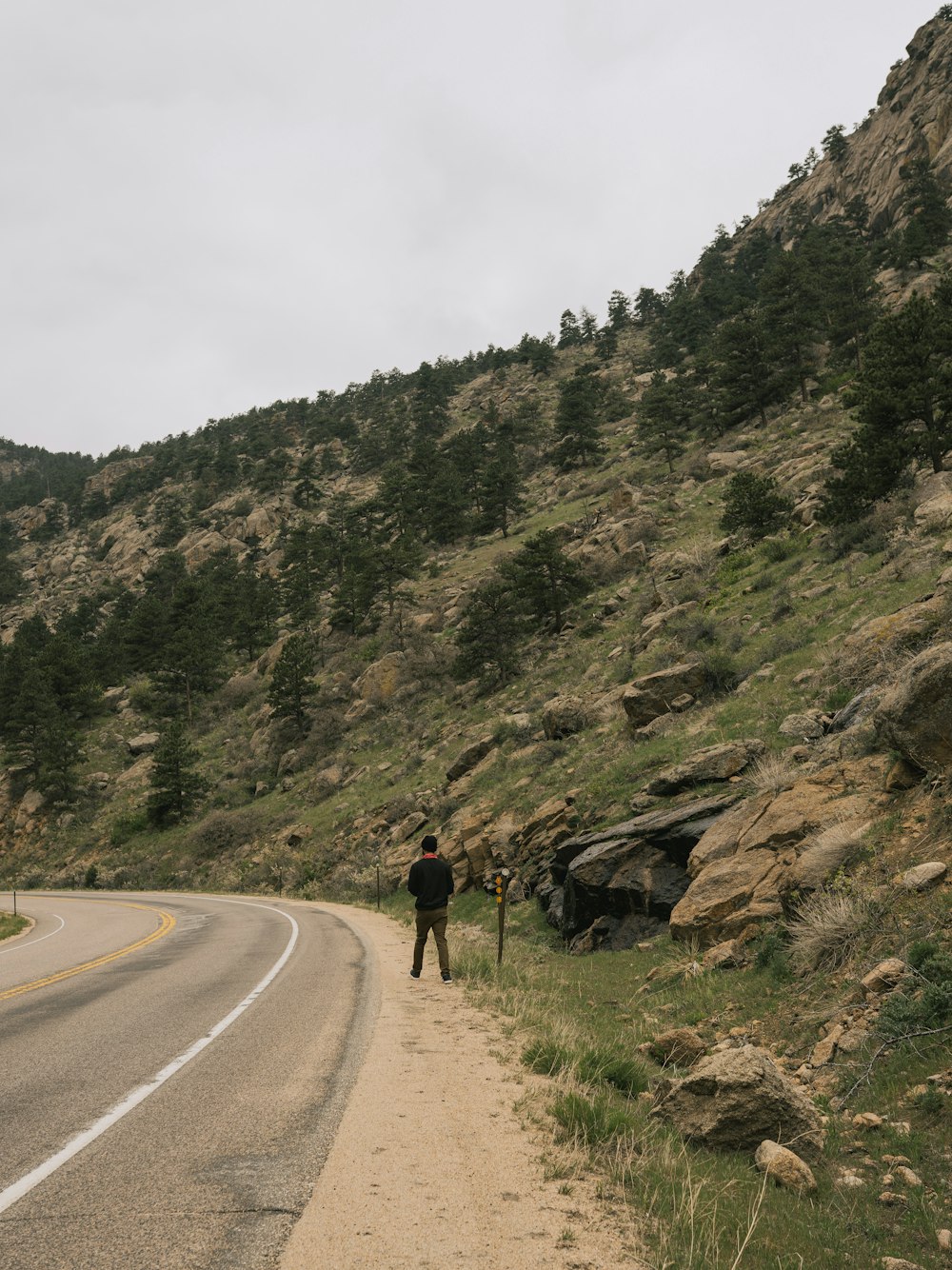 a man standing on the side of a road