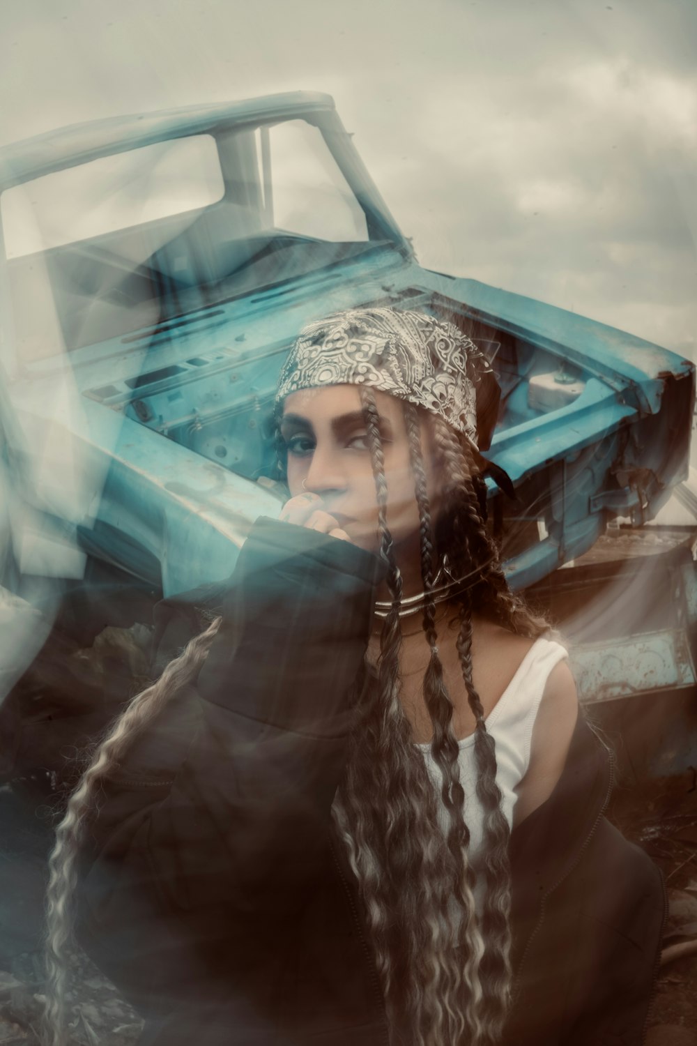 a woman with long hair standing in front of a truck