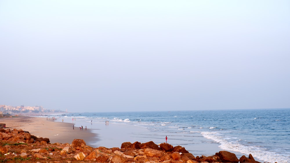 a view of a beach from a rocky cliff