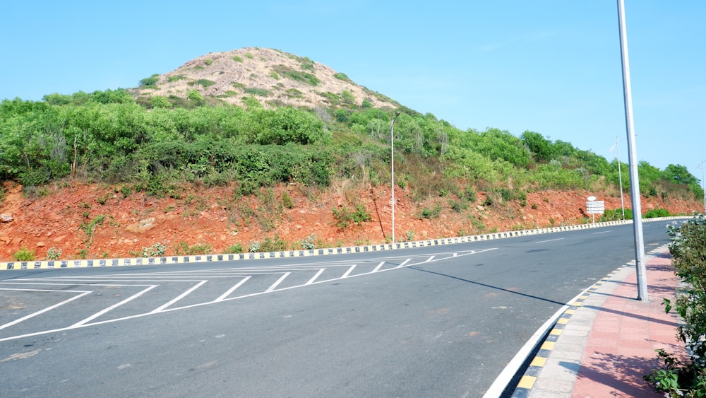 an empty road with a mountain in the background