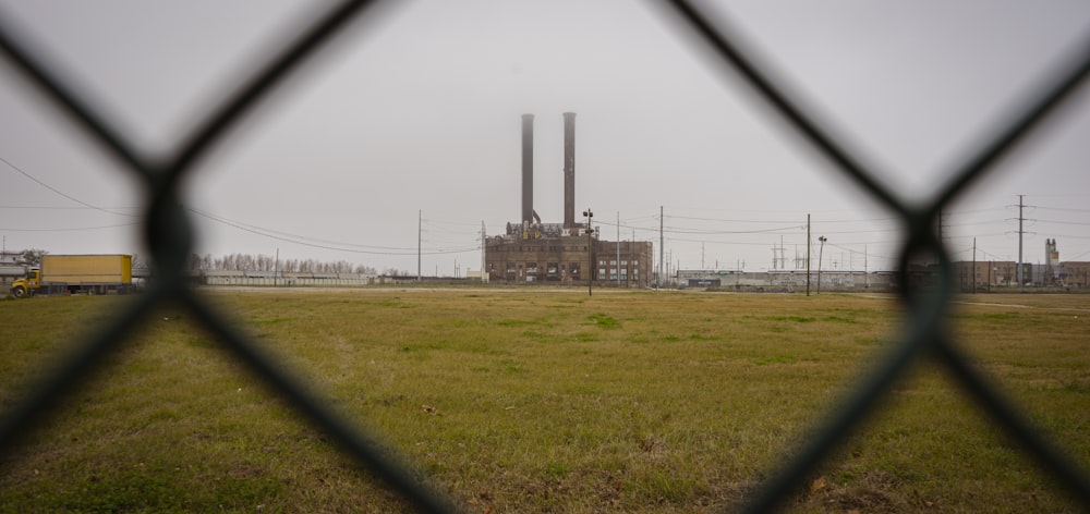 a view of a factory through a fence