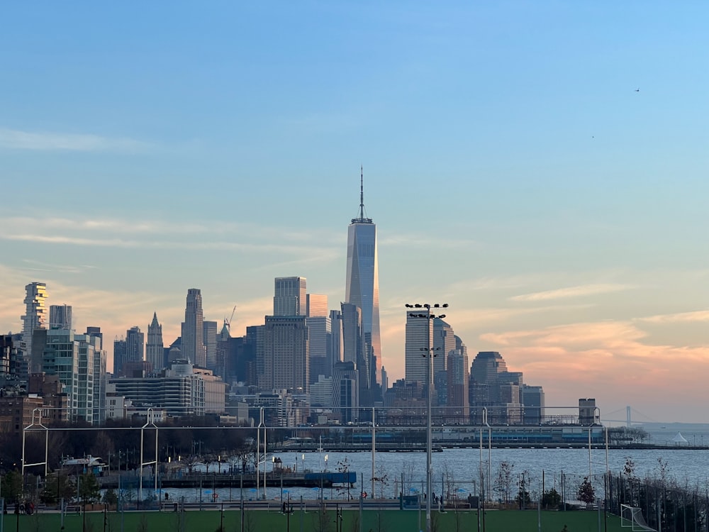 a view of a city skyline with a body of water in the foreground