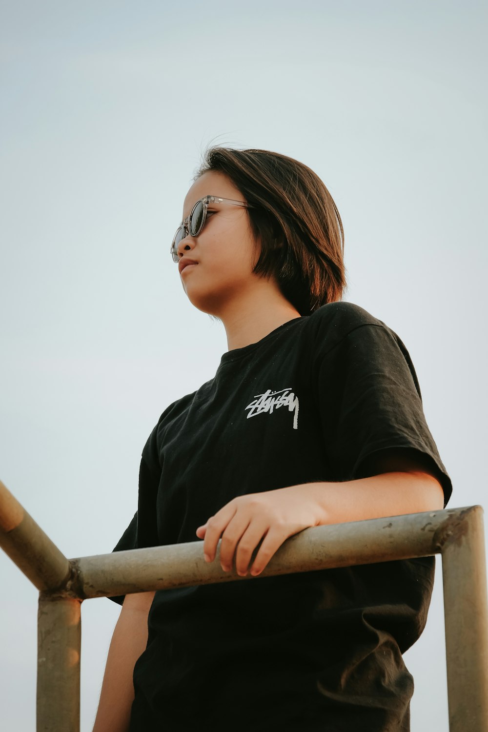 a woman wearing a black shirt and sunglasses