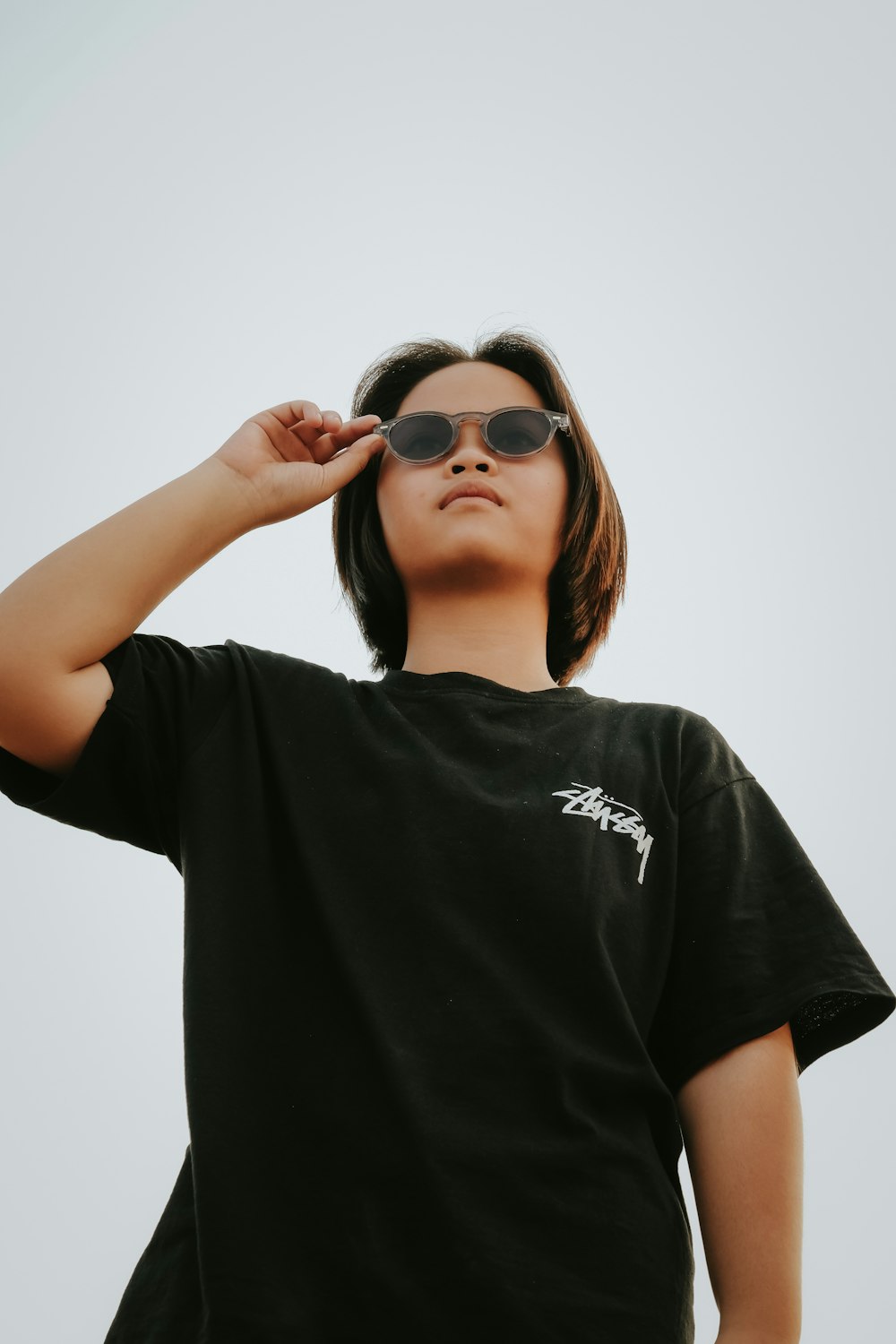 a woman wearing a black shirt and sunglasses