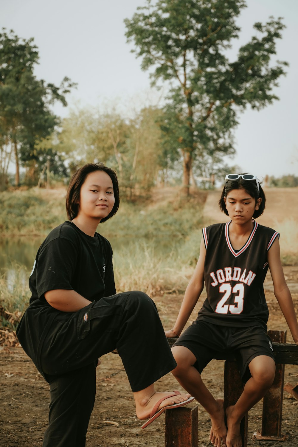 a couple of people sitting on top of a wooden bench