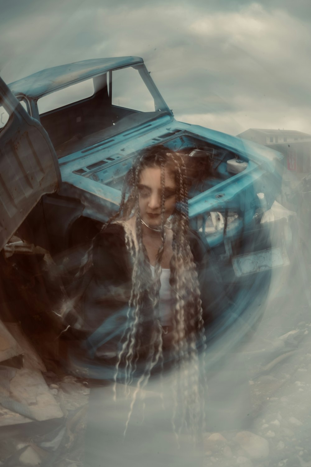 a woman with long hair standing in front of a truck