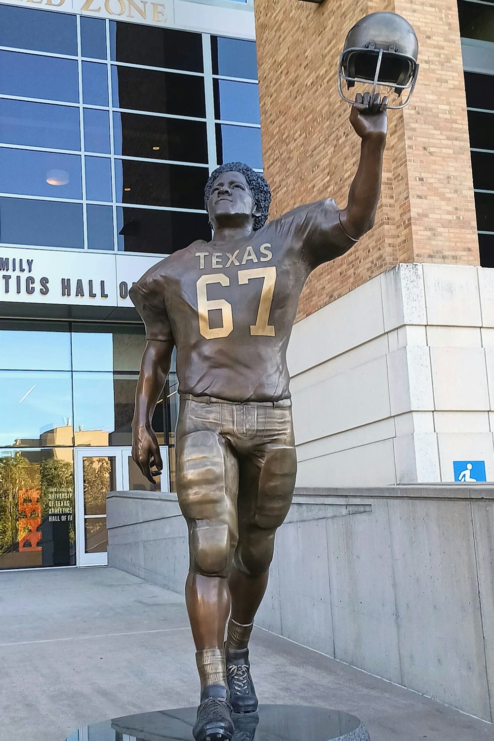 a statue of a football player holding a football