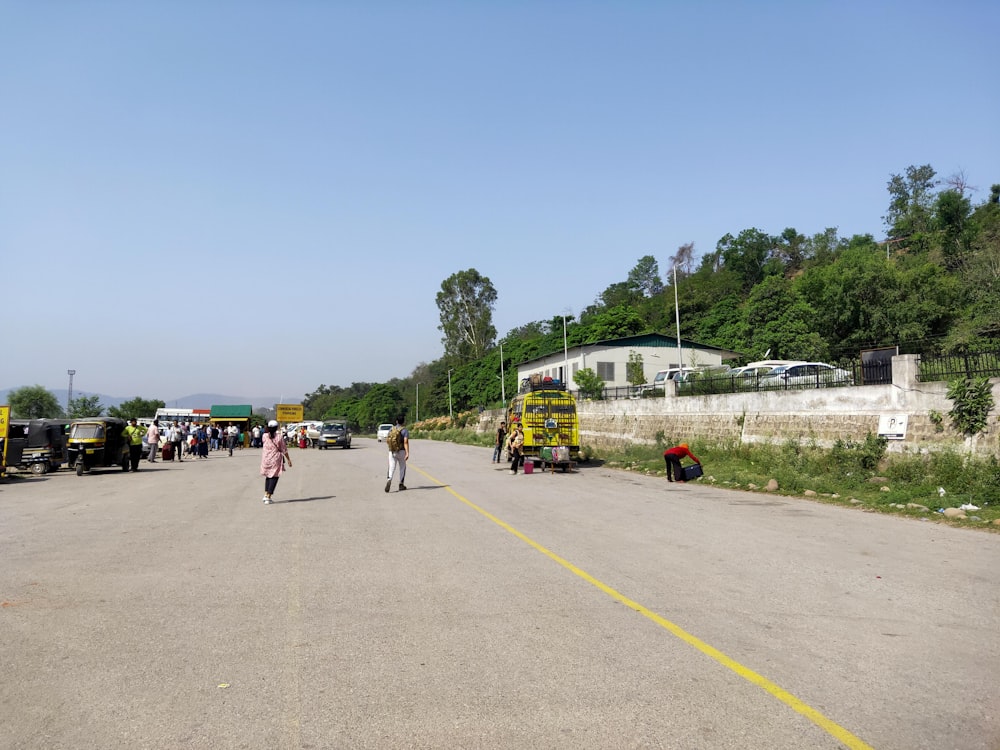 a group of people walking down the middle of a road