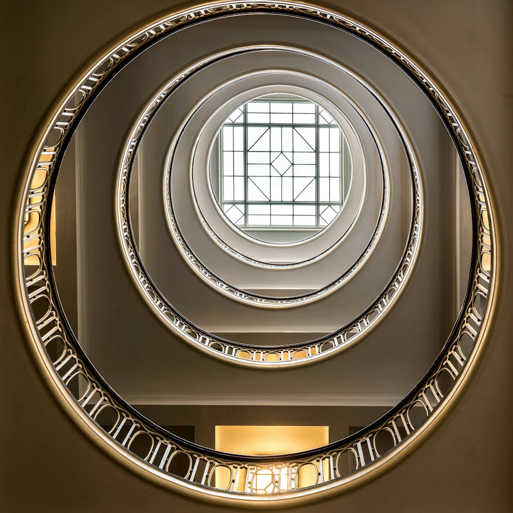 a circular mirror on the wall of a building