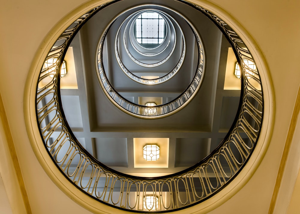 a circular mirror hanging from the ceiling of a building