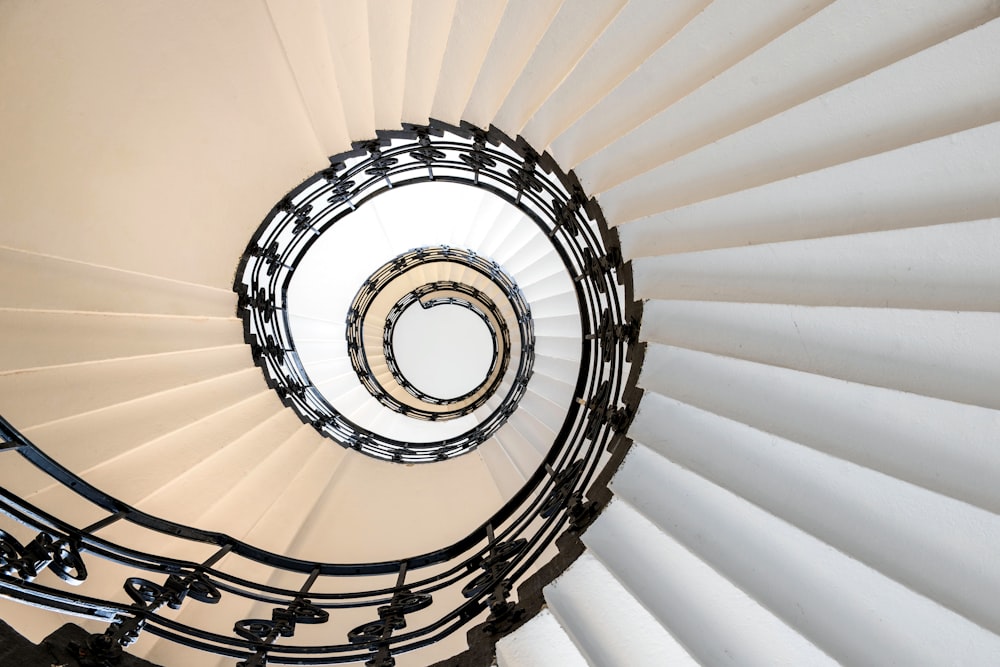 a white spiral staircase with a circular railing