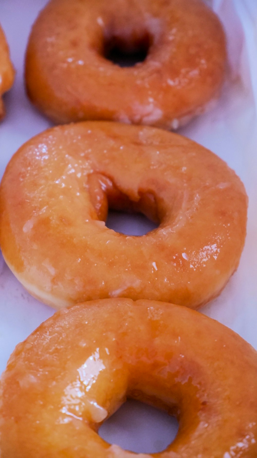 a close up of doughnuts in a box