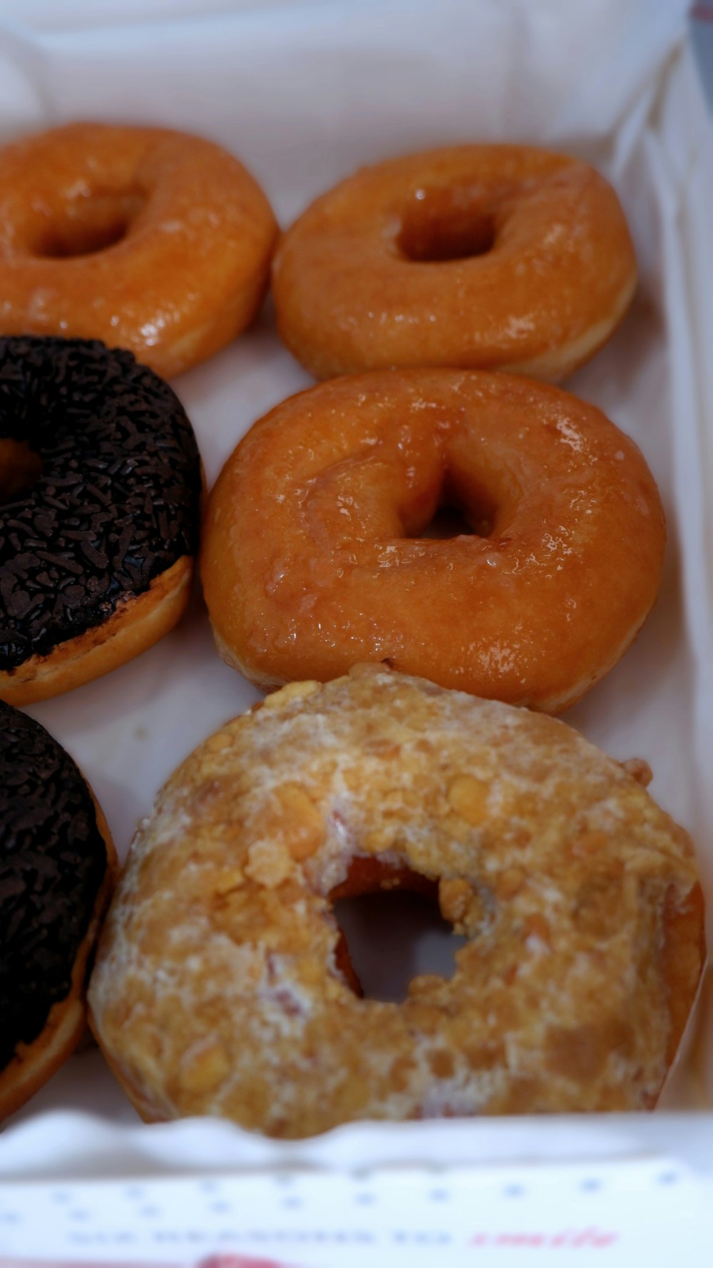 a box filled with lots of different flavored donuts