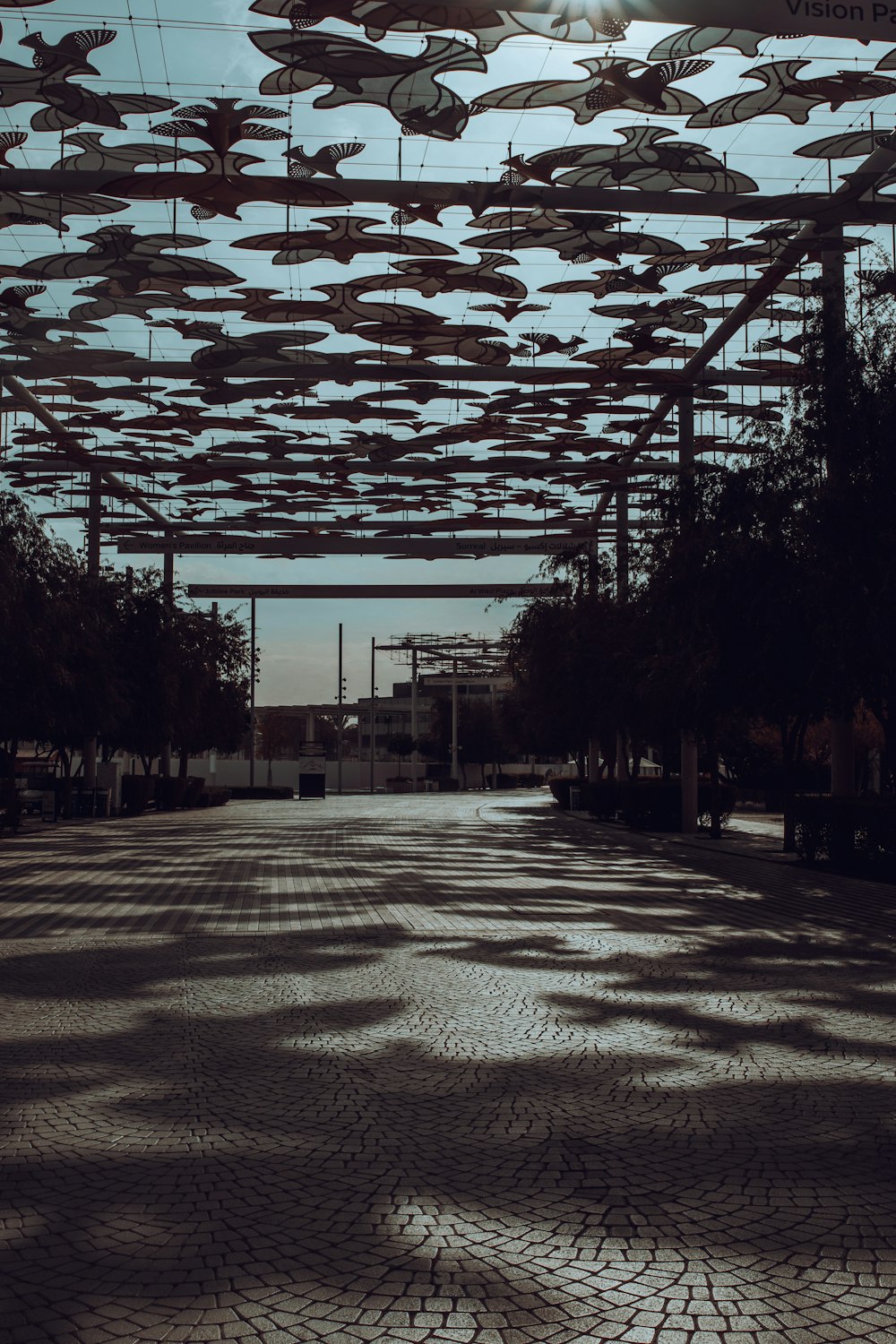 a street with many umbrellas hanging from the ceiling