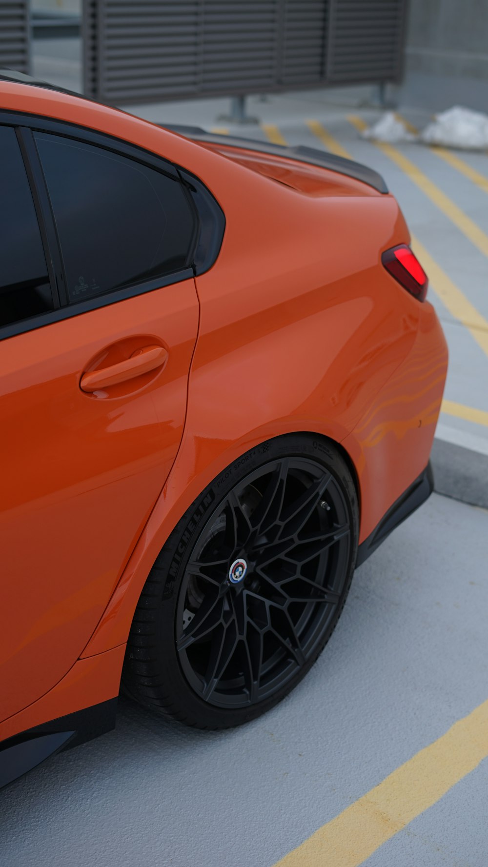 an orange car parked in a parking lot