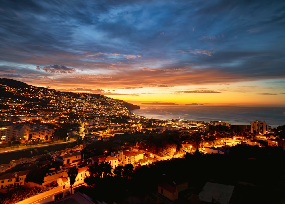 a view of a city at night from a hill