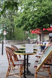 a person sitting at a table with a menu on it