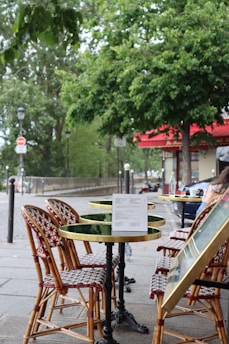 a person sitting at a table with a menu on it
