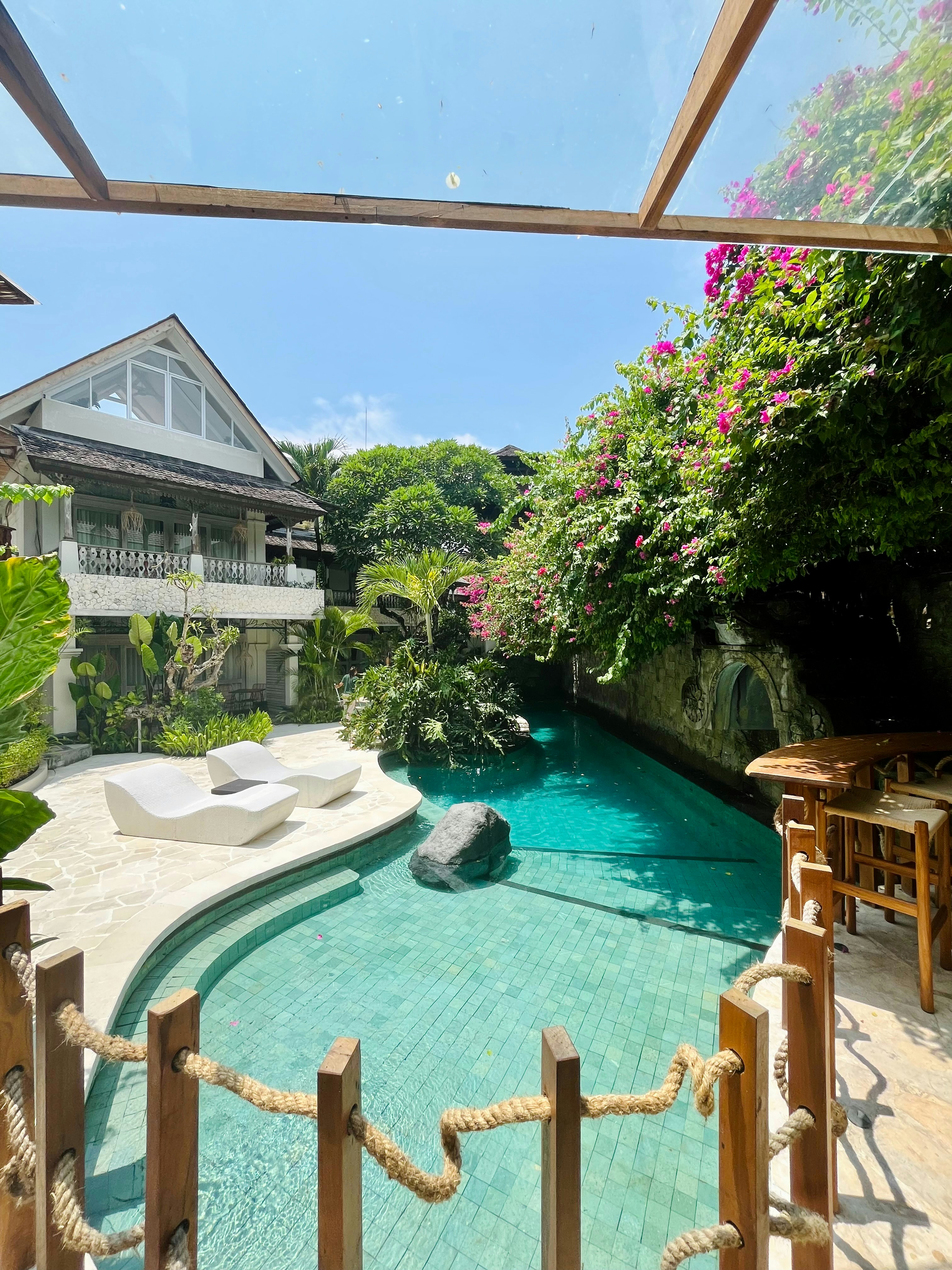 a pool with a rock in the middle of it