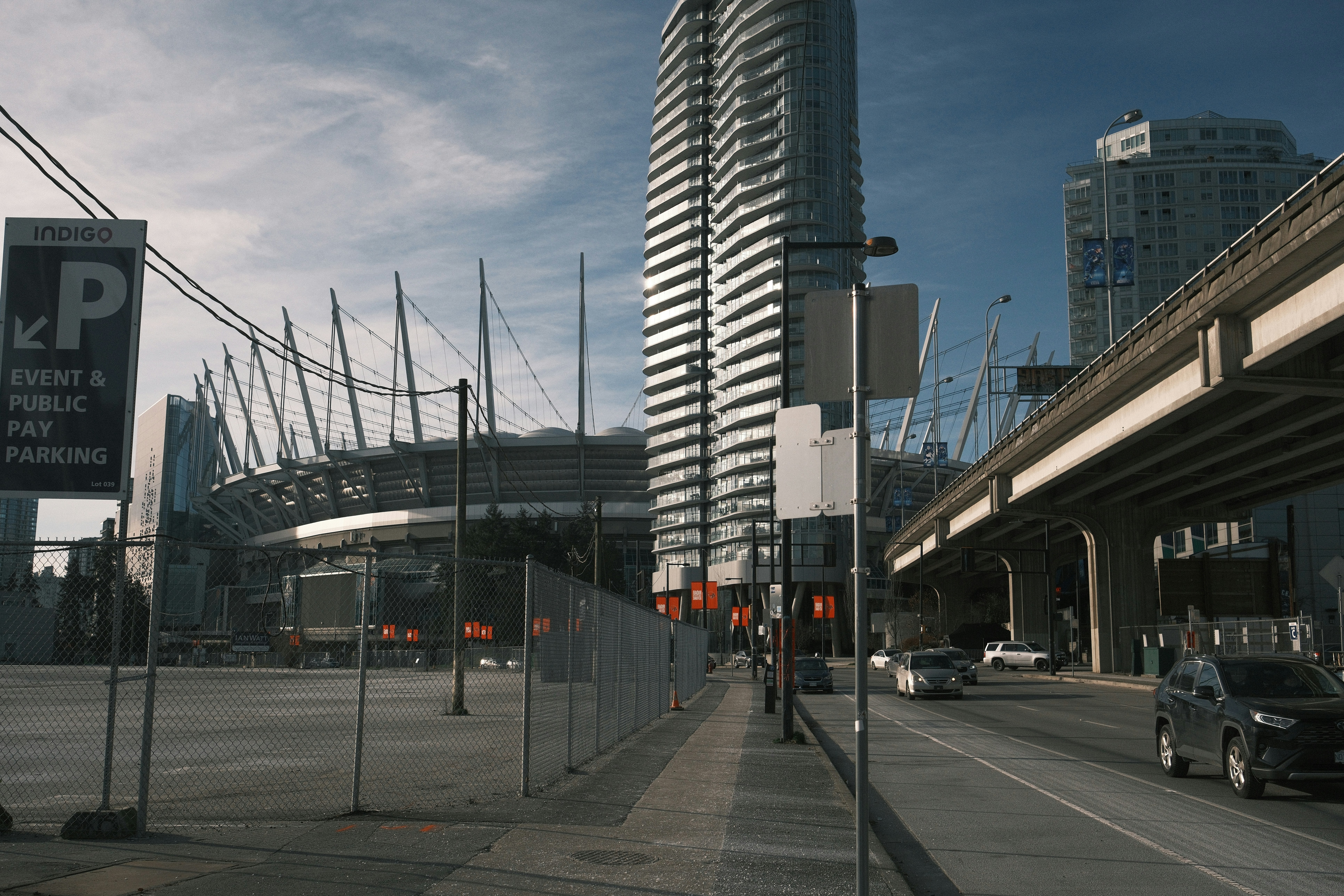 a city street with a tall building in the background