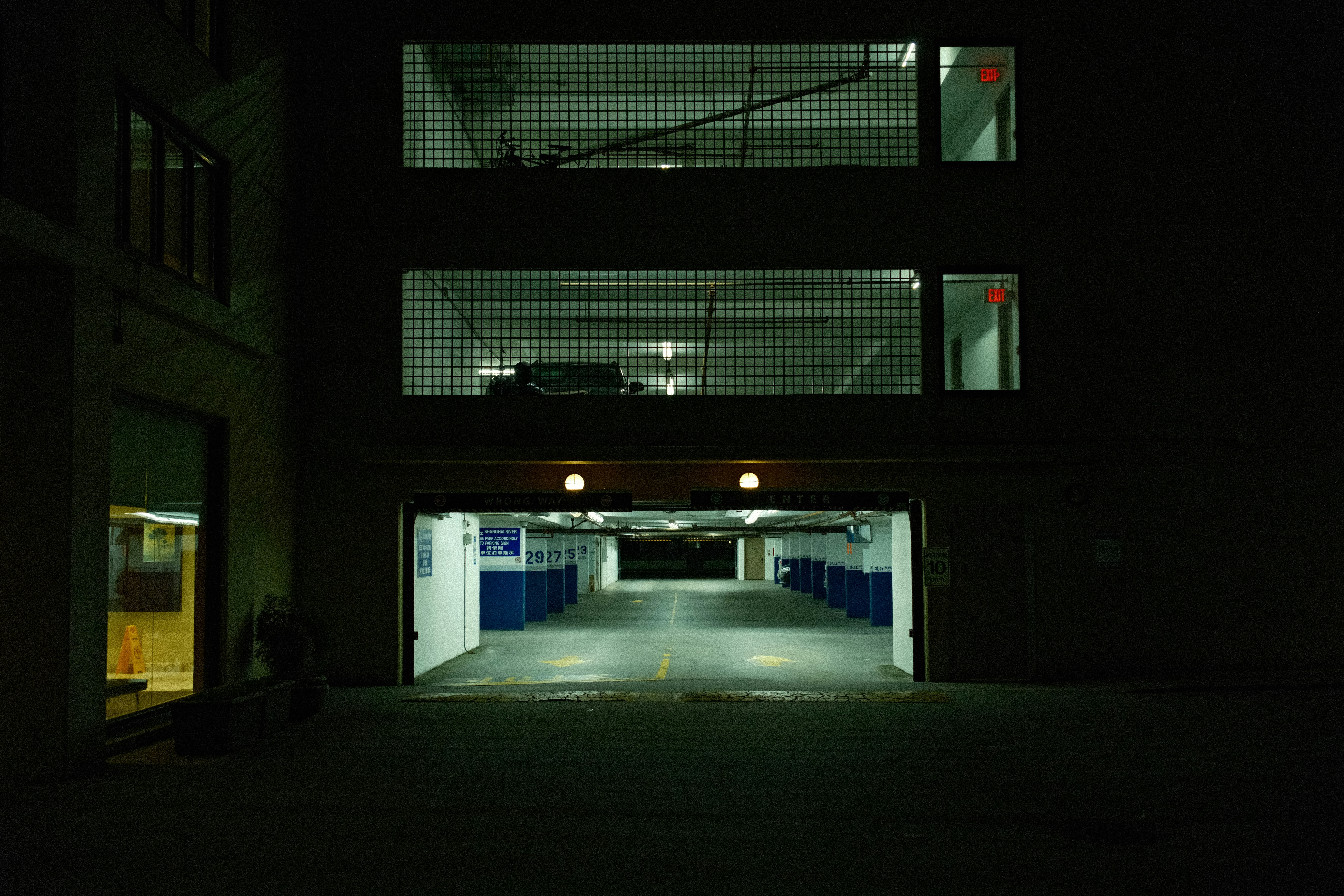an empty parking garage at night with lights on