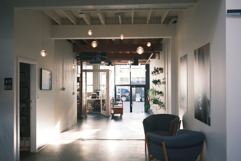 a room with a blue chair and a white wall