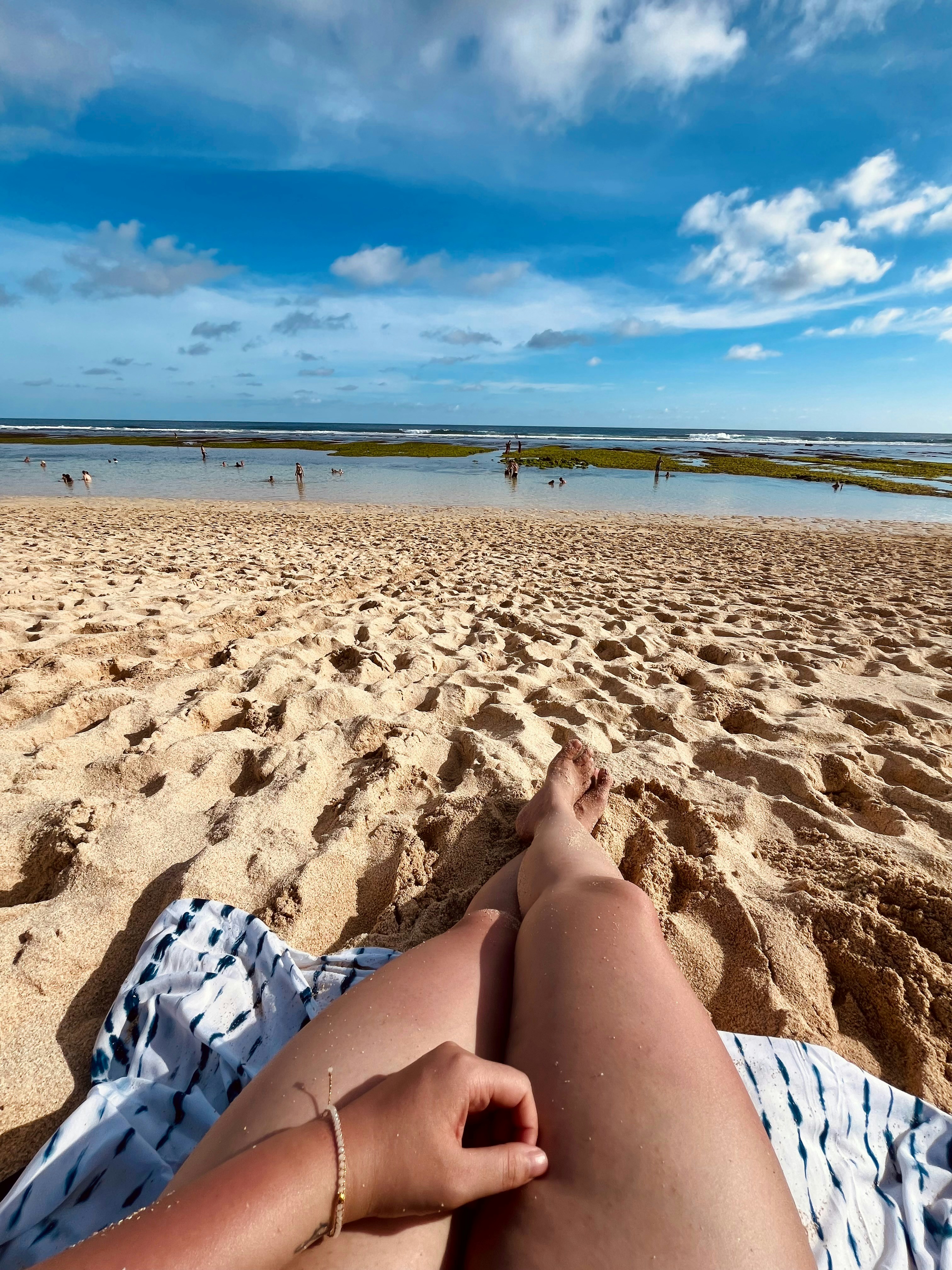 a person laying on a towel on a beach